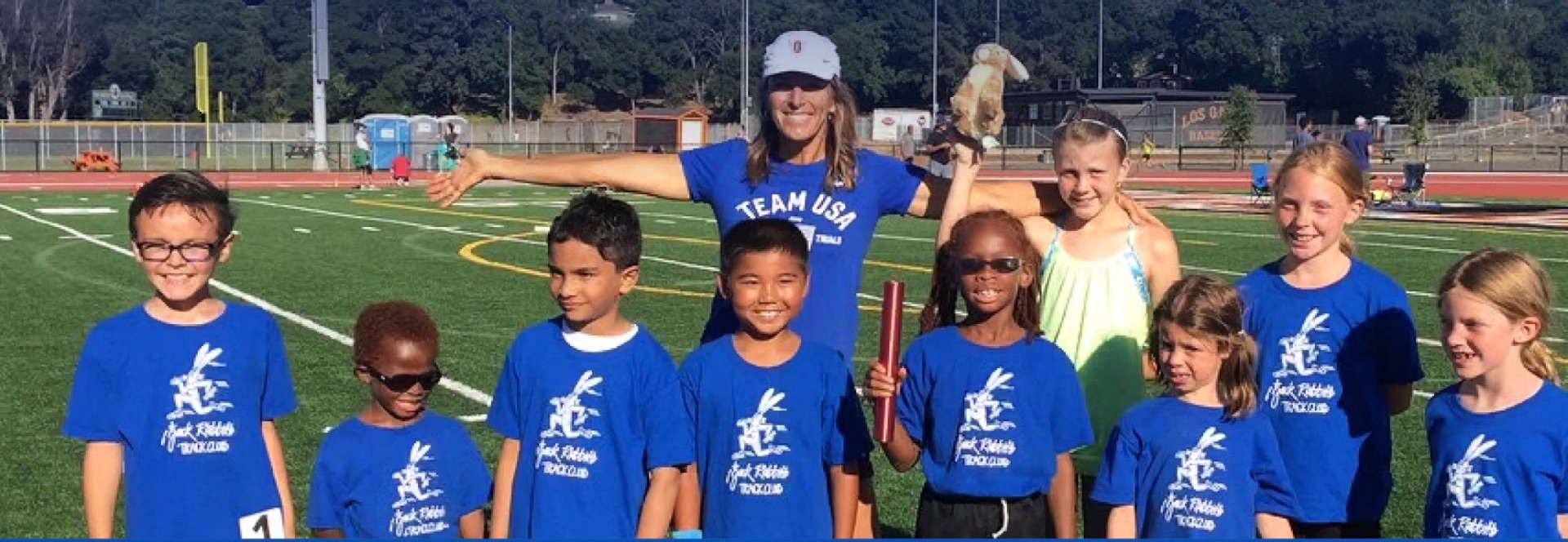 Joy and a Jackrabbits class in blue club shirts on the track
